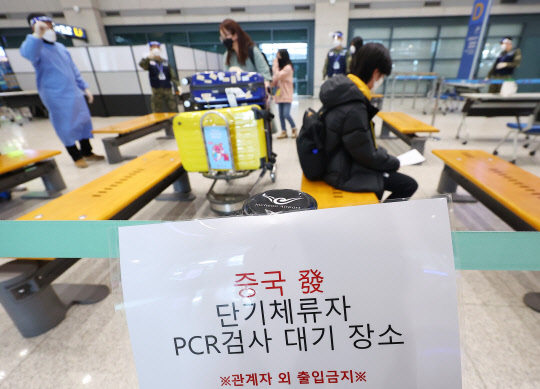 중국에서 출발한 입국자에 대한 코로나19 음성확인서 제출이 의무화된 지 사흘째인 지난 7일 입국자들의 한국 도착 후 양성률이 14.8%를 기록했다. 8일 인천국제공항 제1여객티미널을 통해 입국한 중국발 입국자들이 방역 관계자의 안내를 받고 있다. 연합뉴스